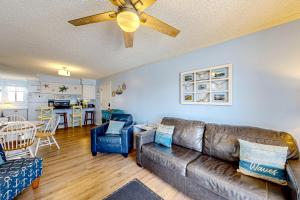 a living room with a couch and a ceiling fan at Ocean Breeze 106B in Emerald Isle