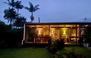 a house with a palm tree on top of it at Quirky little 2 bedroom in quiet cul-de-sac in Kempsey
