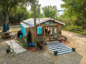 a small shed with a table and a bench at #Y3 Willow Tree Yurt in Drumheller