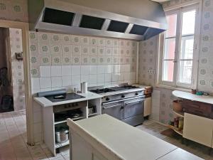 a kitchen with a stove and a sink in it at La Casa Grande de Gormaz in Quintanas de Gormaz