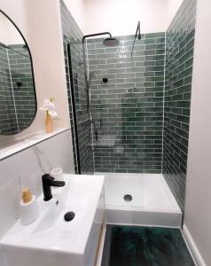 a bathroom with a sink and a shower with a mirror at Stunning High Spec Apartment in Leeds City Centre in Leeds