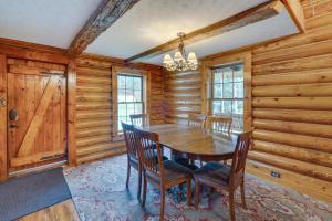 een eetkamer met een houten tafel en stoelen bij Rustic Wellston Cabin with Pond and ATV Trail Access! in Hamden