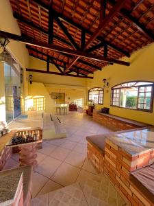 a large room with a fireplace in a building at Recanto dos Passáros Penedo RJ in Penedo