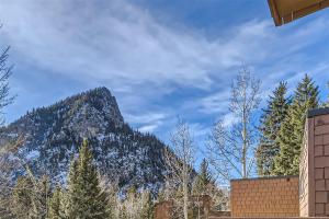 a mountain in the distance with trees and a building at Cabin Creek Condos C-1 condo in Frisco