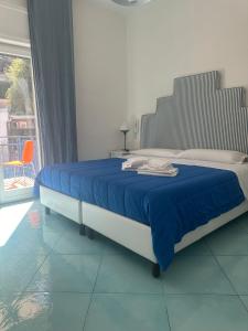 a bedroom with a large bed with a blue blanket at Il Sirenio in Sorrento