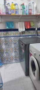 a laundry room with a washing machine and a counter at Dorado 3 in Badalona