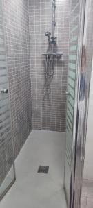 a shower with a glass door in a bathroom at Dorado 3 in Badalona