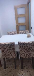 a table and two chairs in a room at Dorado 3 in Badalona