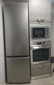 a stainless steel refrigerator and microwave in a kitchen at Dorado 3 in Badalona