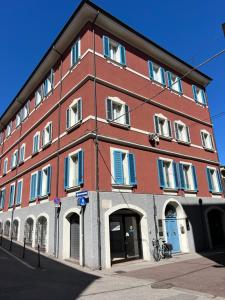 a large red brick building on a street at LaMalatestina Suite - Apartment in front of the Castle in Rimini