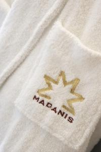 a white towel sitting on top of a white towel at Hotel Madanis in Hospitalet de Llobregat