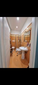 a bathroom with two toilets and a sink and a shower at Home Santa Chiara Marigliano in Marigliano