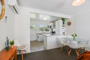 a kitchen and dining room with a table and chairs at Home Base in Rotorua