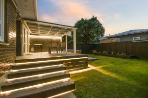 a backyard with a deck with a table on it at Home Base in Rotorua