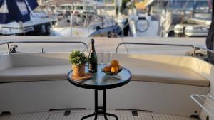 a table with a bottle of wine and fruit on a boat at Cosy and Homey Houseboat Castelldefels in Barcelona