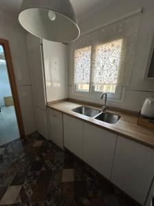 uma cozinha com um lavatório e uma janela em Apartamento Ve&Va em Torre del Mar