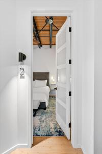 a white door leading into a bedroom with a bed at Hotel Residential of Denver in Denver