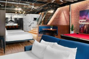 a room with a bed and a pool table at Hotel Residential of Denver in Denver