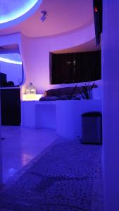 a room with a bed with a purple lighting at Spa Chaac in Puerto Vallarta