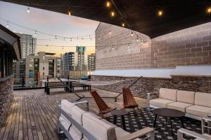 a rooftop patio with couches and a table and chairs at Hotel Residential of Denver in Denver