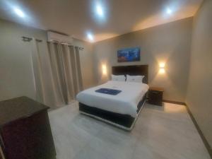 a bedroom with a large white bed in a room at WHITE SHARK RESORT in Ponta do Ouro