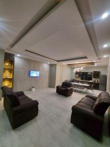 a large living room with couches and a television at WHITE SHARK RESORT in Ponta do Ouro