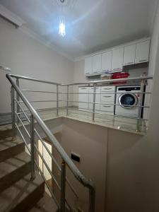 a staircase in a room with a kitchen with a stove at CN Villa Didim in Didim