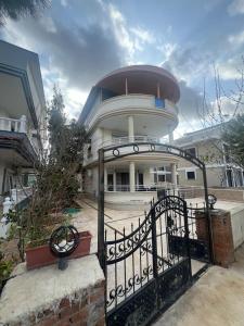 a building with a gate in front of it at CN Villa Didim in Didim