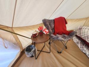 a table and a chair in a tent at #Y5 Lumberjack Lounge Yurt in Drumheller