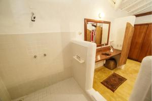 a bathroom with a sink and a mirror at Pousada El Gordo in Trancoso