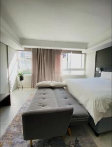 a bedroom with a large bed and a large window at WINK Hotel- Next to CTICC & Best Tourist Location in Cape Town