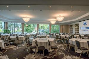 une salle de banquet avec des tables, des chaises et des lustres dans l'établissement Hilton Amsterdam, à Amsterdam