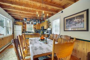 a kitchen and dining room with a table and chairs at Waitsfield Home with Hot Tub - Close to Sugarbush! in Waitsfield