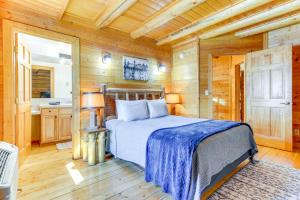 a bedroom with a bed in a wooden cabin at Cozy Mountain Condo Across From Snow King Ski Mtn! in Jackson