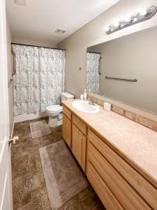 a bathroom with a sink and a toilet and a mirror at Cozy home - sleeps 12 - RV parking - Sun Room in Star