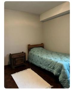 a bedroom with a bed and a night stand at Amplio Apto al este de Caracas in Caracas