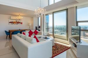 a living room with a white couch and red pillows at Mirage by McStay in Cape Town