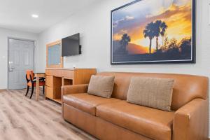 a living room with a couch and a desk at Countryside Inn Sealy in Sealy