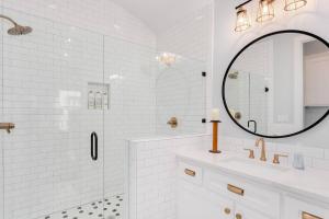 a white bathroom with a sink and a mirror at The Brownstone-1 Block to Downtown Bentonville in Bentonville +34 photos