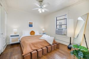 a bedroom with a bed and a ceiling fan at The Clementine - Monthly Rental - Walk Everywhere in Fayetteville