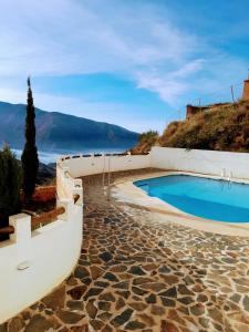 a swimming pool with a view of the ocean at Apartamento Valentino's- Alpujarra in Carataunas