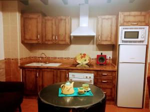 a kitchen with a table with two cups on it at Apartamento Valentino's- Alpujarra in Carataunas