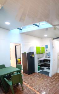 a kitchen with a green table and a refrigerator at CASA DANY in Guaduas