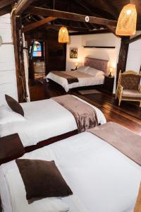 Voodi või voodid majutusasutuse Spa Hosteria Miramelindo toas
