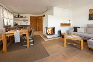 sala de estar con mesa y chimenea en Ferienlandhaus Alpinum en Lenggries