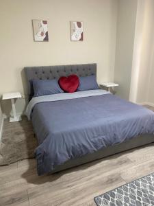- un lit avec un oreiller à cœur rouge dans l'établissement Chlo apartment 5 Tirane, à Tirana