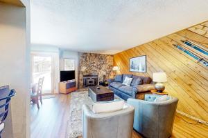 a living room with a couch and a table at Snowcreek 443 in Mammoth Lakes