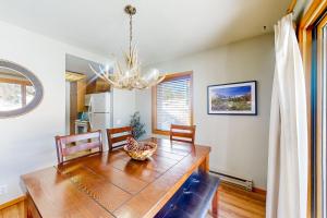 a dining room with a table and a chandelier at Snowcreek 443 in Mammoth Lakes