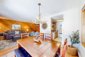 a dining room and living room with a wooden table at Snowcreek 443 in Mammoth Lakes