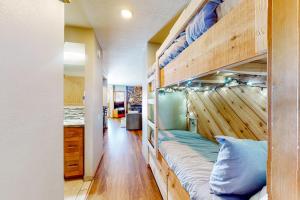 a room with a bunk bed with a wooden wall at Snowcreek 443 in Mammoth Lakes